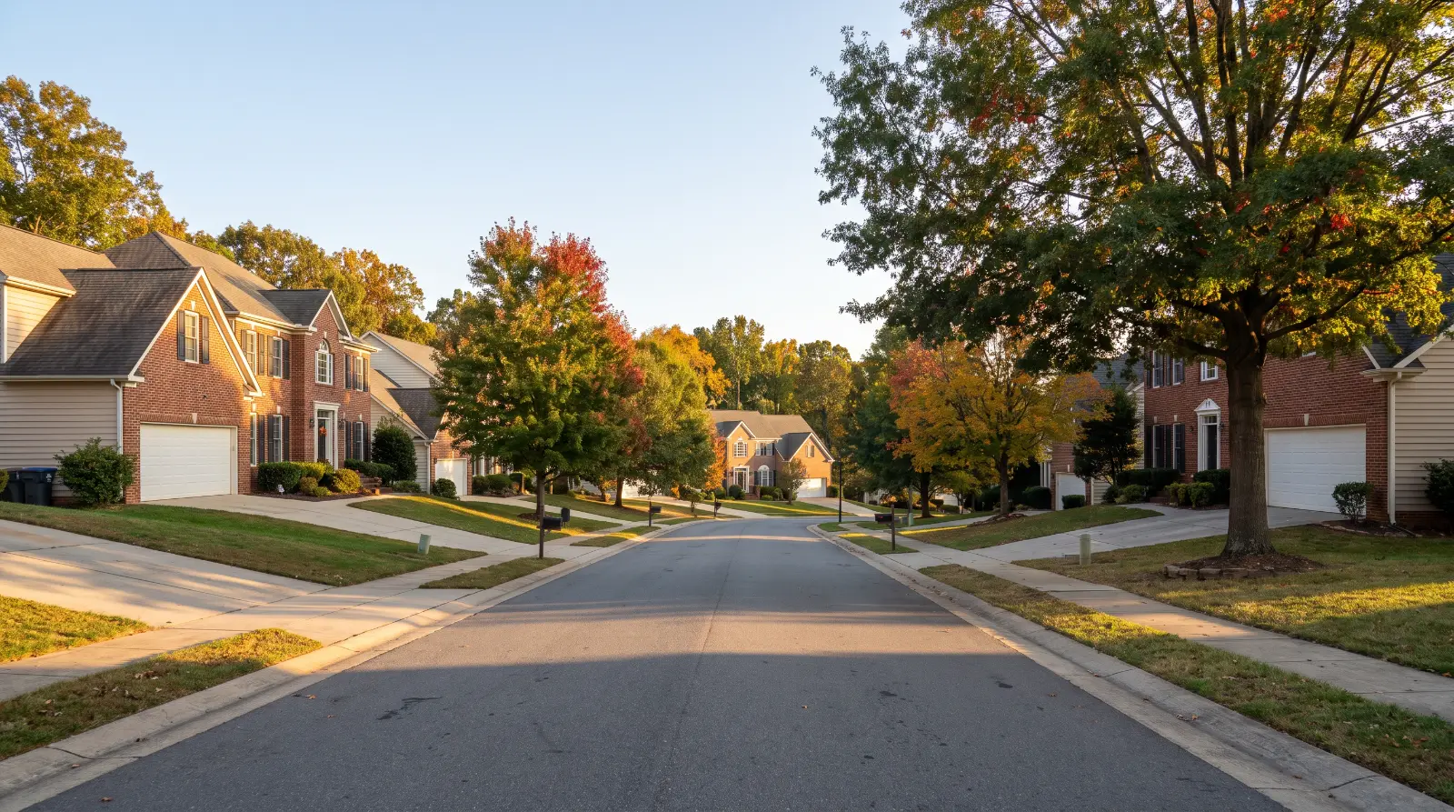 Suburban street with brick homes and attached garages